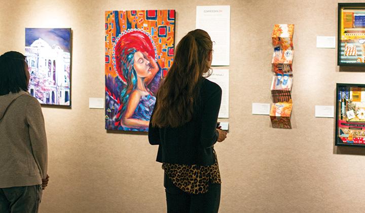 Person looking at art display on a gallery wall